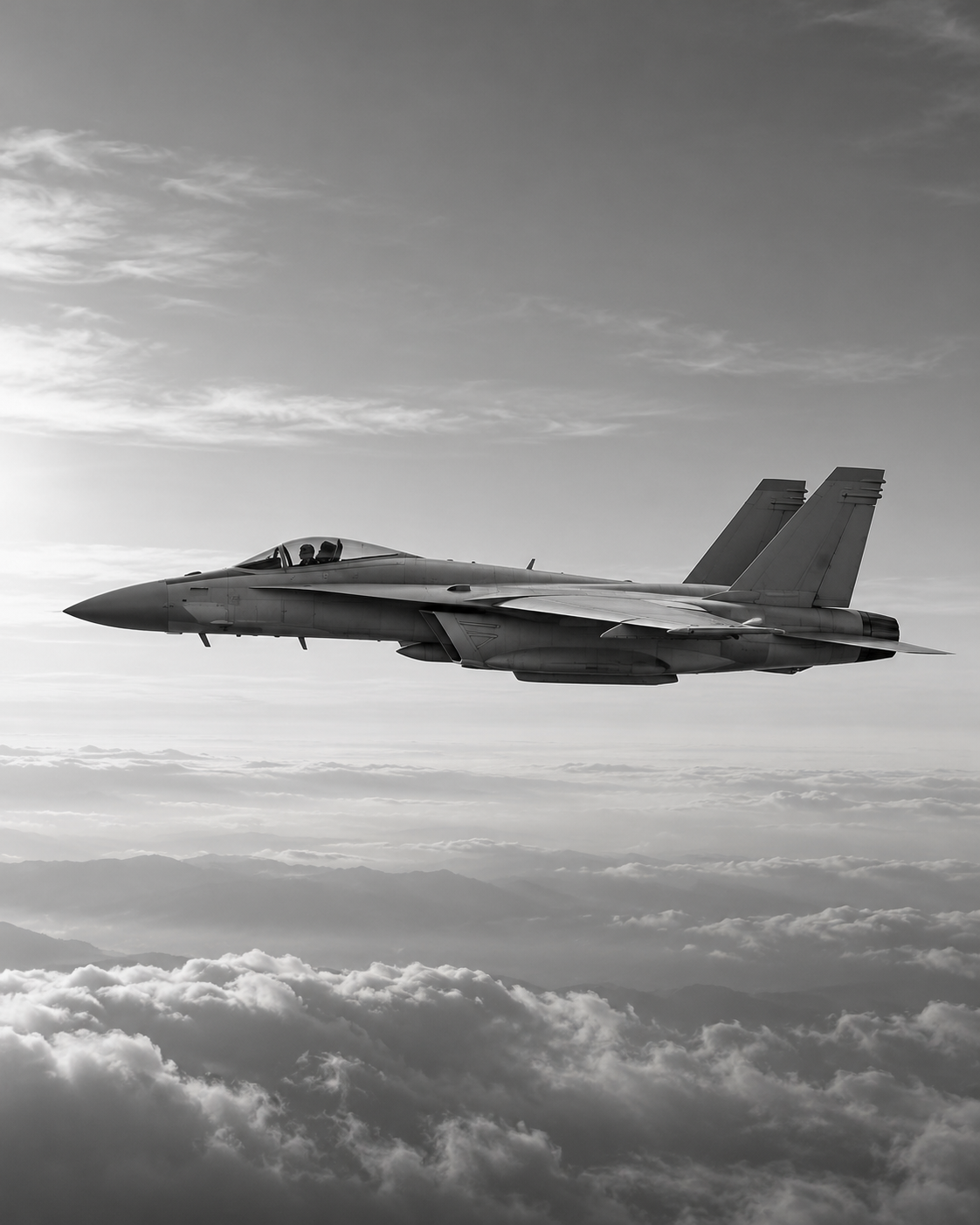A fighter jet in side profile above clouds, in monochrome.